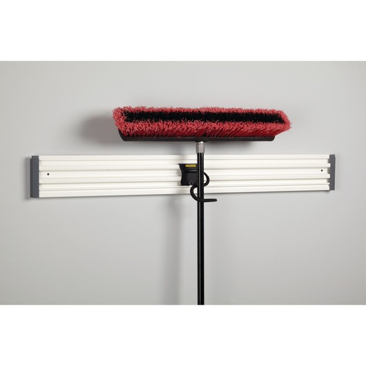 STANLEY STST82605-1 wall-mounted storage rail with broom and hook attachment, front angle.