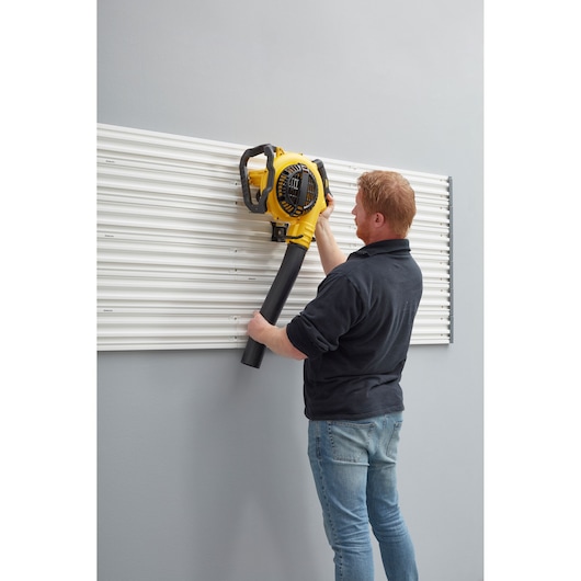 STANLEY STST82609-1 photography of wall panel used to hang a yellow leaf blower.