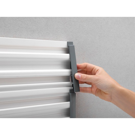 STANLEY STST82611-1 hand adjusting grey wall-mounted metal rail, close-up angle.