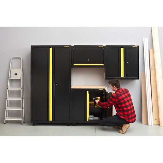 Photo of STANLEY STST97957-1 black and yellow storage cabinets in workshop, front angle.