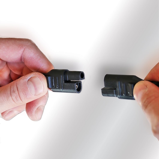 STANLEY SXAE00025GB connector cable close-up held by two hands, white background.