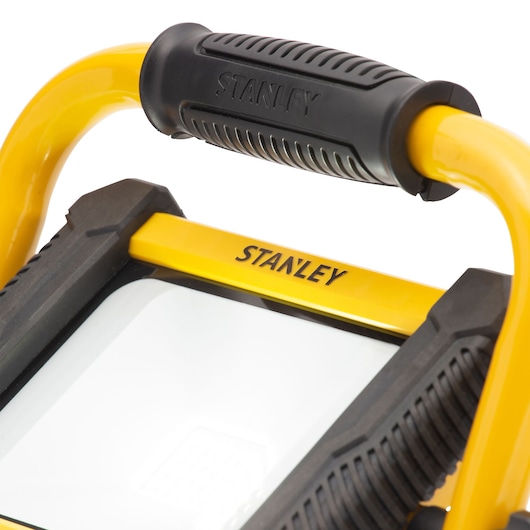 STANLEY SXLS31334E portable work light close-up, yellow frame, black handle, white background.