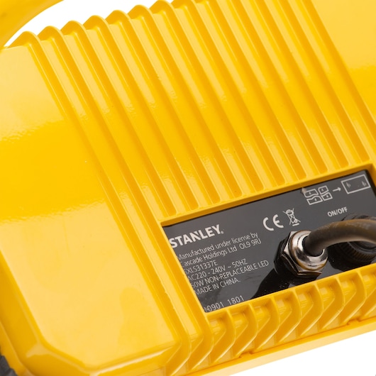 STANLEY SXLS31337E yellow device close-up, showing ribbed surface, label, and power cord on white background.