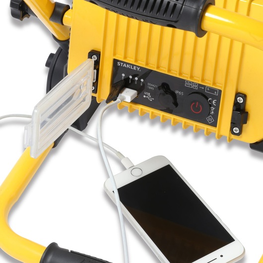 STANLEY SXLS31338E work light with yellow frame, close-up of USB port charging a white smartphone.