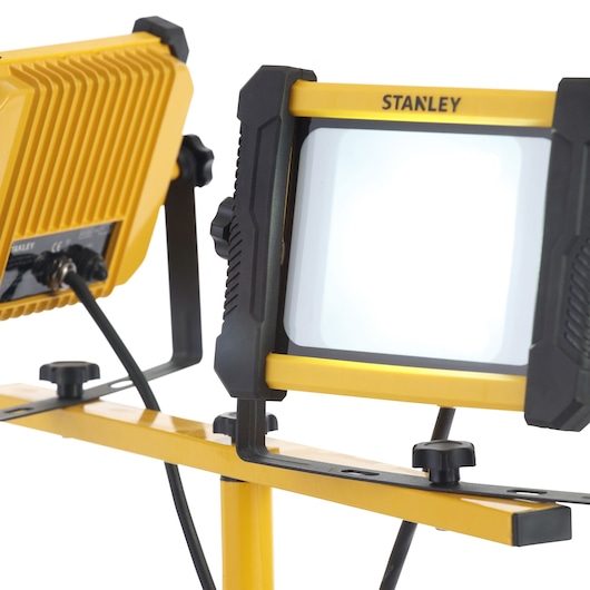 STANLEY SXLS31540E dual-head LED work light on stand, yellow and black, side angle photo.