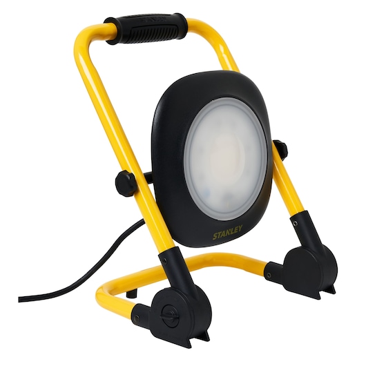 Photo of STANLEY SXLS35527E photography work light with yellow frame, black handle, and round LED head, front angle.