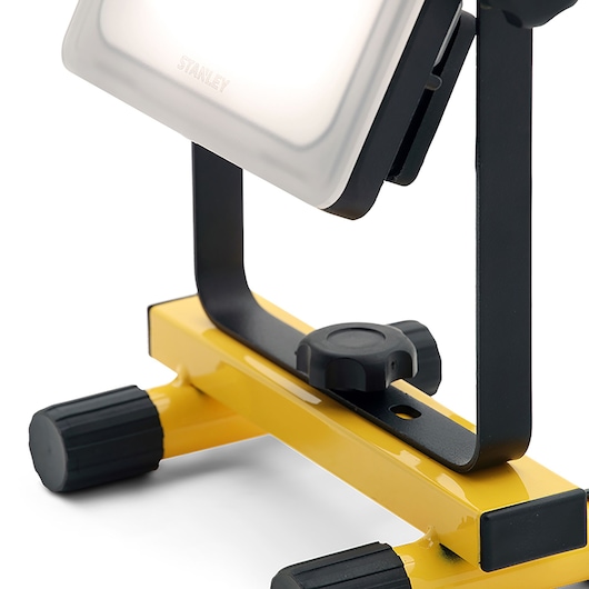 STANLEY SXLS36383E work light close-up, showing yellow base and adjustable black stand, product photography.