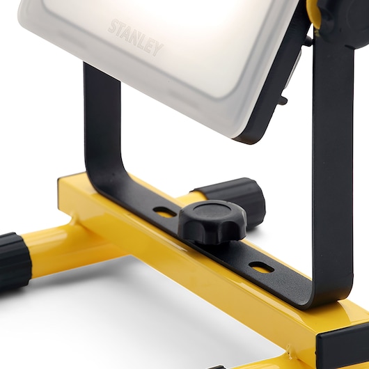 STANLEY SXLS36384E LED work light close-up, showing adjustable black metal bracket and yellow base, front angle.