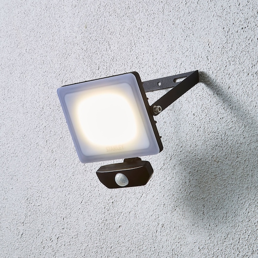 STANLEY SXLS38935E outdoor LED floodlight with motion sensor, wall-mounted, side angle.