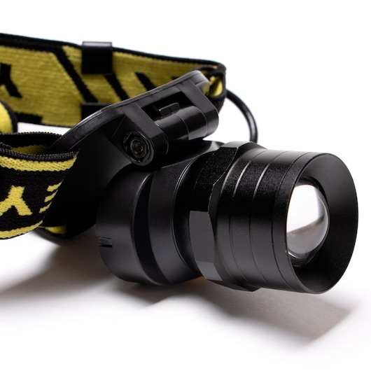 STANLEY SXLS50101E headlamp with black casing and yellow adjustable strap, side angle on white background.