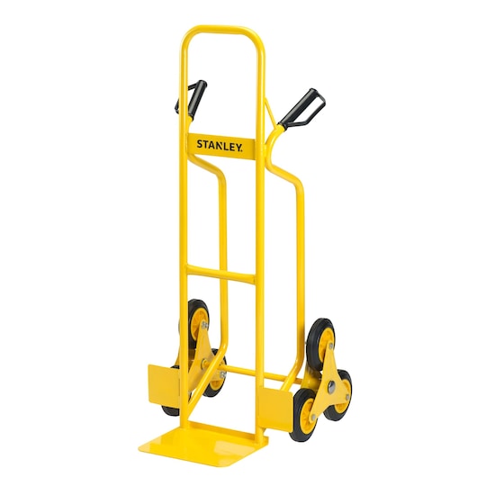 Yellow STANLEY stair climbing hand truck with triple wheel design and ergonomic handles.