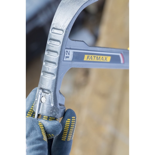 STANLEY XTHT1-51148 hammer close-up, held in gloved hand, showing silver head and FATMAX branding.